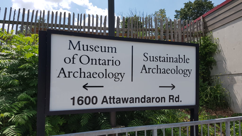 The primary sign of the Museum of Ontario Archaeology indicating the Museum to the left and Sustainable Archaeology to the right. The address, 1600 Attawandaron Ro. is also included.
