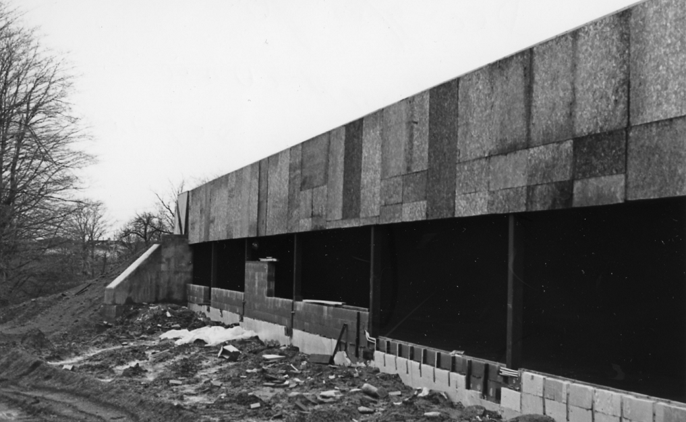 The rear of the Museum of Ontario Archaeology under construction. Concrete blocks are arranged along the wall between structural columns. Window spaces are voids into the interior