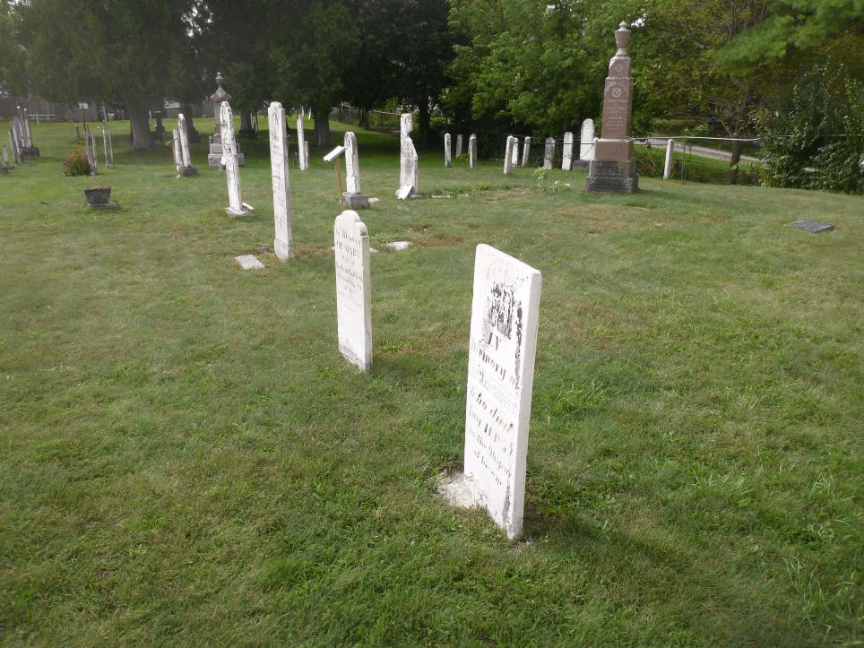 Image of the mostly white headstones of the Griffith Plots Looking Southwest - Brick Street Cemetery