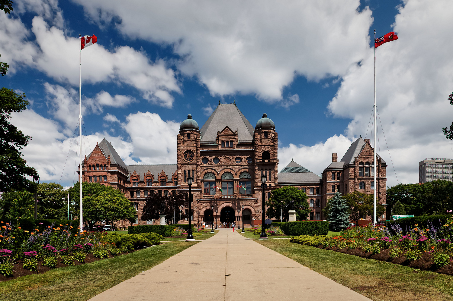 Ontario Legislature on a sunny day, flags waving in the breeze