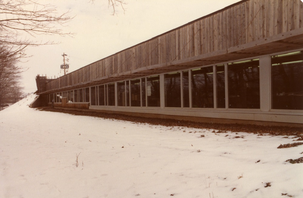 The south bank of windows at the Museum of Ontario Archaeology in the 1980s. A long row of windows overhung with a a wooden lattice and facing the Medway Valley.