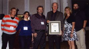Five TMHC representatives accept the 2013 Award for Excellence in CRM from the Ontario Archaeological Society representative.