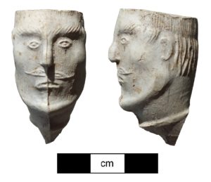 The bowl of an effigy pipe showing a carved male head.