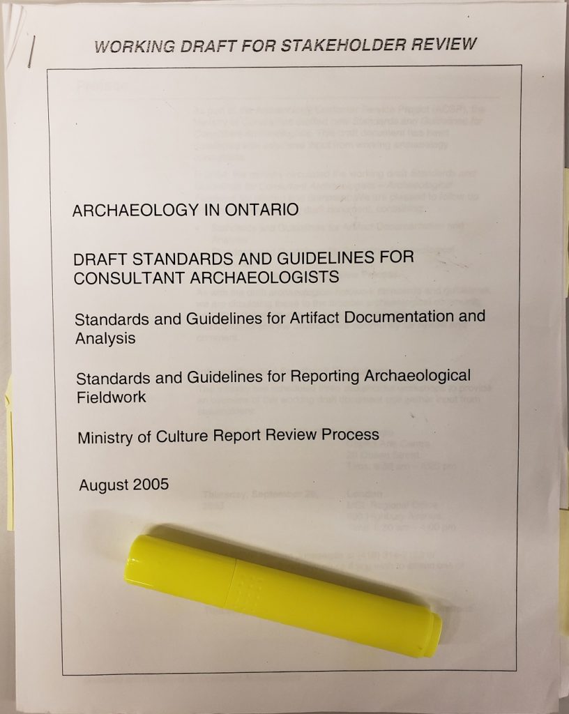 The cover page of Archaeology in Ontario Draft Standards and Guidelines for Consultant Archaeologists: Standards and Guidelines for Artifact Documentation and Analysis, Standards and Guidelines for Reporting Archaeological Fieldwork, Ministry of Culture Report Review Process, August 2005. A highlighter rests on the cover.