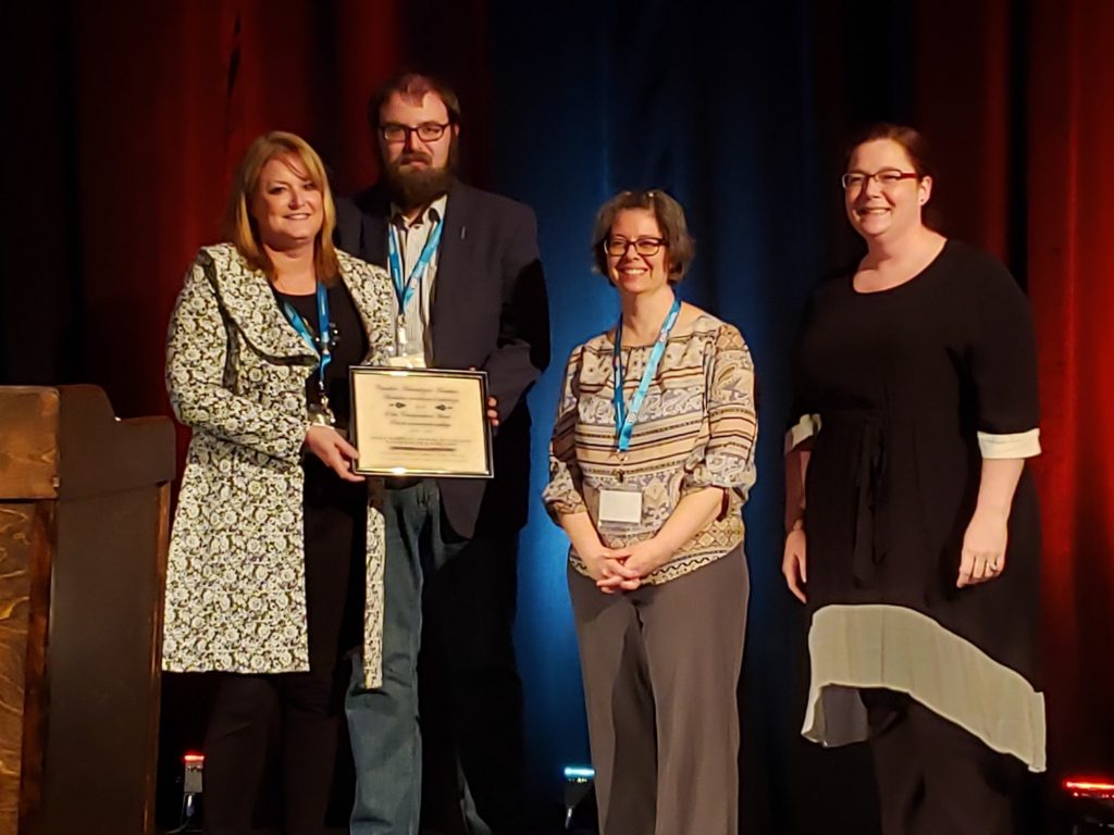 TMHC representatives (Holly Martelle, Matt Beaudoin, Nicole Brandon) pose with the Canadian Archaeological Association Public Communication Award in 2019.
