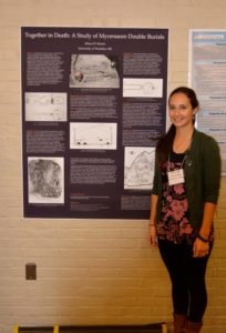 Marya D’Alessio stands in front of a poster about double Mycenaean story