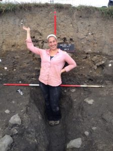 Alex Kisielewski stands in a deep excavation at Vindolanda Field School